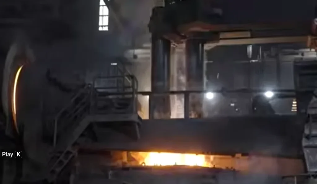 Industrial furnace melting ferrous scrap metal in a steel plant